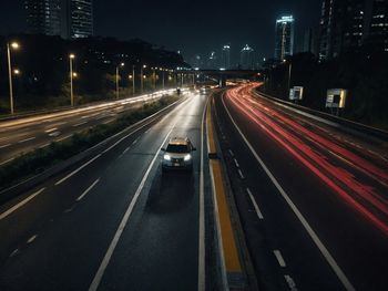 High angle view of light trails on road at night