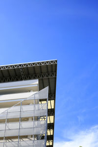 Low angle view of modern building against blue sky