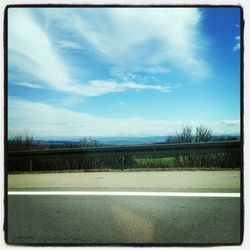 Empty road against blue sky