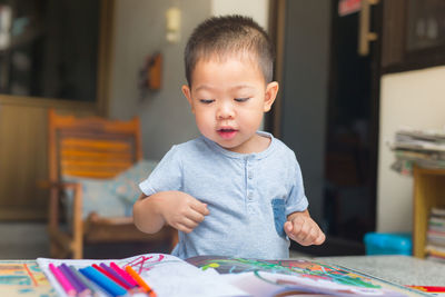 Close-up of boy sitting at home