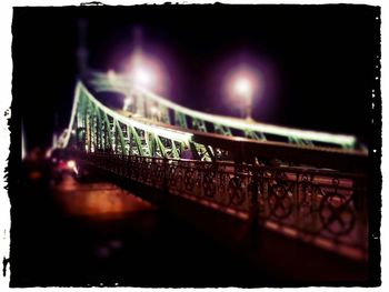 Illuminated bridge at night