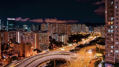 High angle view of illuminated buildings against sky at night