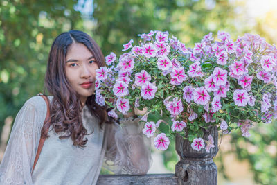 Portrait of beautiful woman with pink flowers