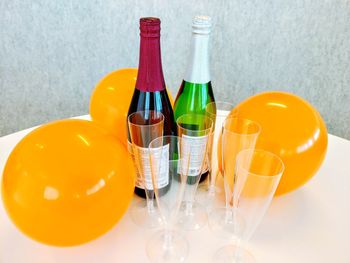 High angle view of champagne bottles with balloons on table