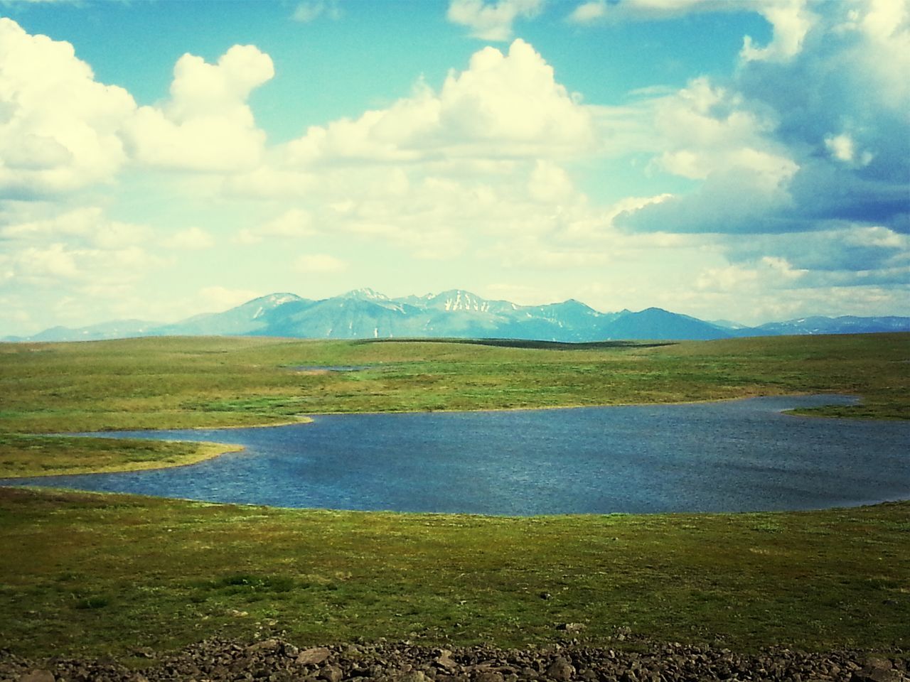 tranquil scene, sky, tranquility, water, mountain, scenics, beauty in nature, cloud - sky, lake, landscape, grass, nature, cloud, mountain range, cloudy, idyllic, non-urban scene, river, reflection, countryside