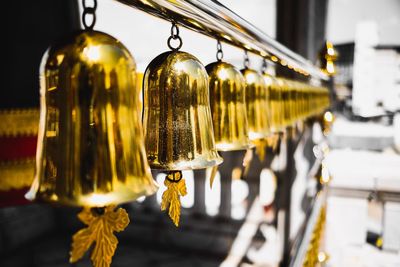 Close-up of illuminated lamp hanging in temple