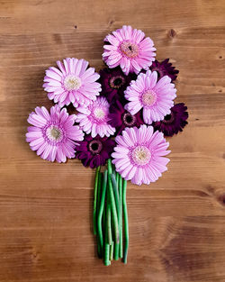 Close-up of flowers on wooden plank