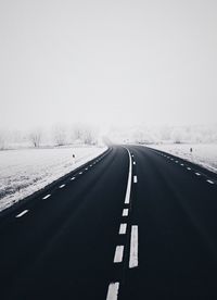 Highway in winter against sky