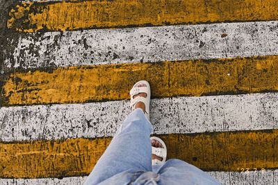 Low section of person standing on footpath