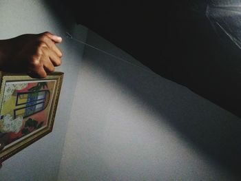 High angle view of person hand on wall