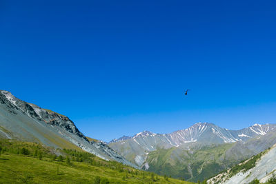 Scenic view of mountains against clear blue sky