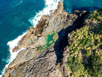 High angle view of rock by sea