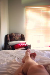 Low section of woman on bed