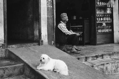 Man with dog sitting on steps