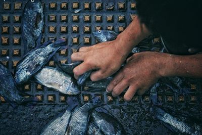 Close-up of man working on barbecue grill