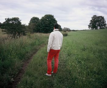 Rear view of man standing on field