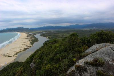 Scenic view of sea and mountains against sky