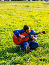 Man playing guitar on field
