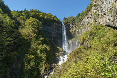 Scenic view of waterfall against sky