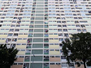 Low angle view of trees against building