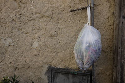 Close-up of clothes hanging on built structure