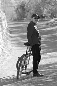 Man riding bicycle on road in city