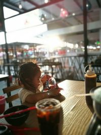 Portrait of young girl at outdoor table