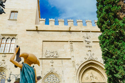 Low angle view of statue against building