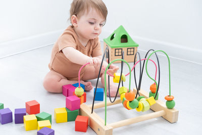 Full length of girl playing with toys at home