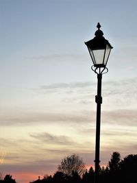 Low angle view of street light against sky during sunset