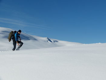 Full length of person on snowcapped mountain against sky