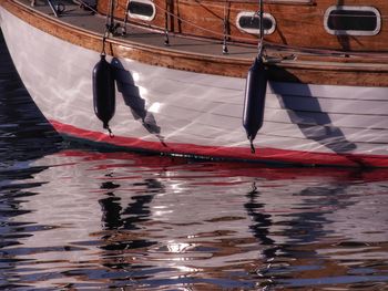 Wooden boat and bouys on water. 