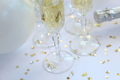 High angle view of wine with confetti on table