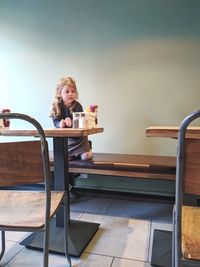 Woman sitting on chair at table