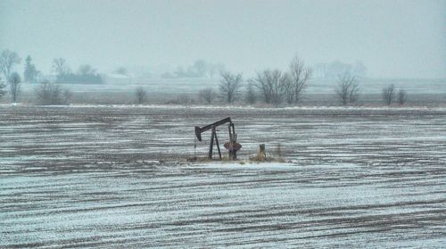 Scenic view of field against sky during winter