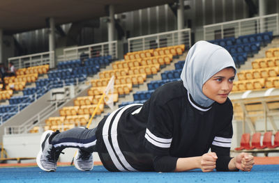 Athlete wearing hijab while exercising on sports track