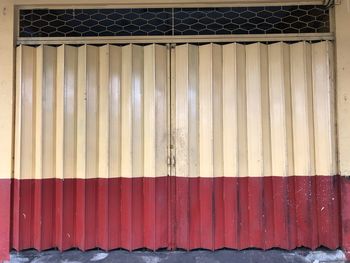 Close-up of red fence against wall