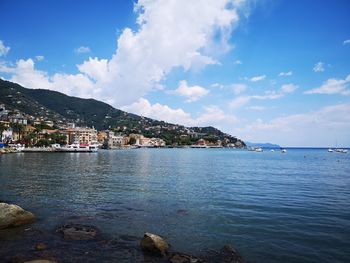 Scenic view of sea by city against sky