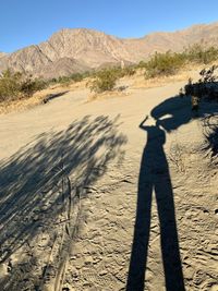 Shadow of person on desert land