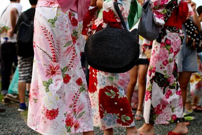 Rear view low section of people walking outdoors