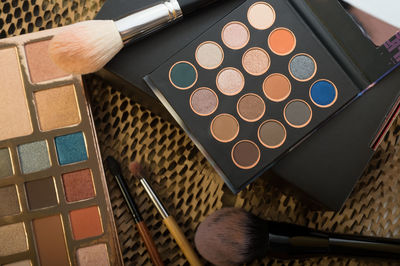 High angle view of eyeshadow palettes on table