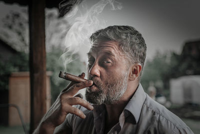 Portrait of man smoking cigarette