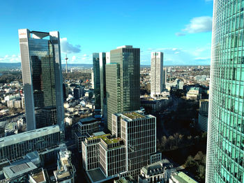 Aerial view of modern buildings in city against sky