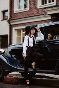 Side view of young woman in car