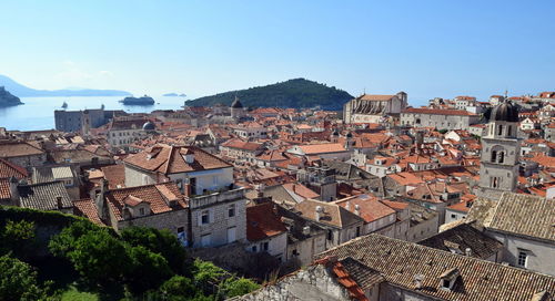 High angle view of houses in town against clear sky