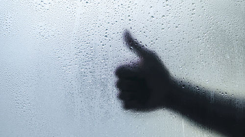 Shadow of person on glass window