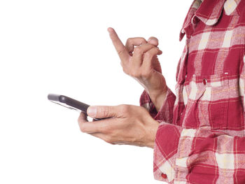 Close-up of man holding hands against white background