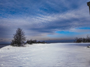 Scenic view of snow covered landscape against blue sky