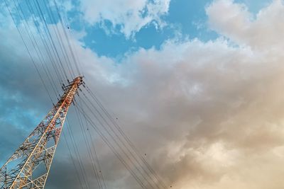 Low angle view of crane against sky