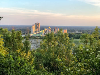 Panoramic view of trees and buildings against sky